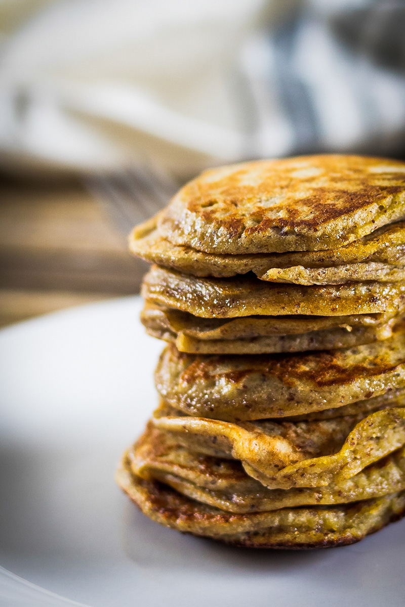 up close stack of almond flour banana pancakes on a white plate
